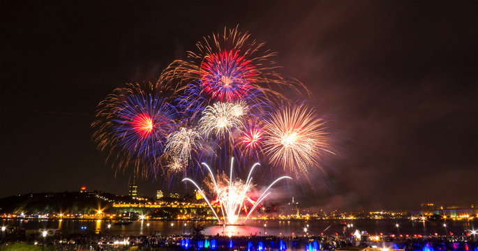 Blue, red, and white fireworks during a summer festival in Quebec City, Canada.