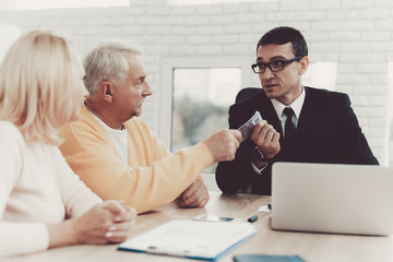 Old Man and Woman Visiting Young Lawyer in Office.