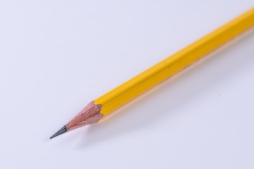 Single isolated yellow lead graphite pencil with a white background