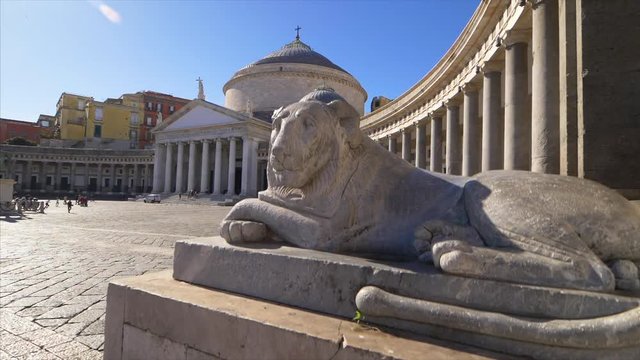 Stone lion statue in front of Piazza del Plebiscito in Naples, Italy, slow motion