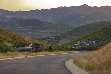 Winding downhill street with homes in valley