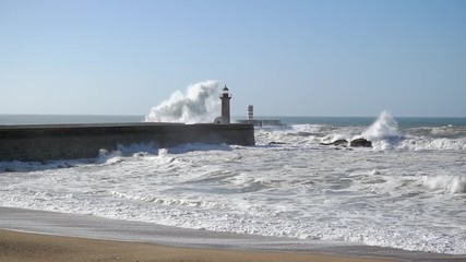 Waves crashing on Lighthouse in Foz of Douro in slow motion, Portugal