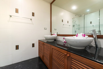 Luxury bathroom features basin, toilet bowl and bathtub