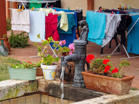 Water well and drying clothes in the courtyard of a Camino pilgrim hostel - Moratinos, Castile and Leon, Spain