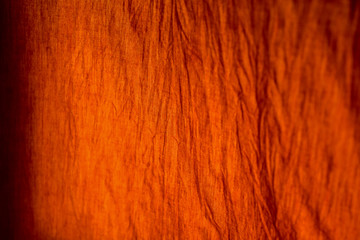 yellow robe of Buddhist monk pattern background with sunlight.