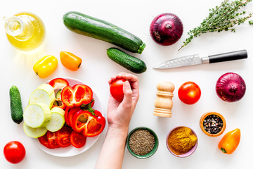 Healthy food concept. Ingredients for vegetable stew. Squash, bell pepper, tomato, spices, oil on white background top view