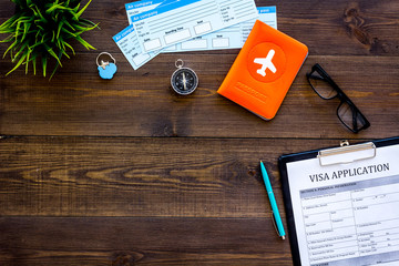 Planning a vacation, planning a trip. Visa application form near passport and airplane ticket on...