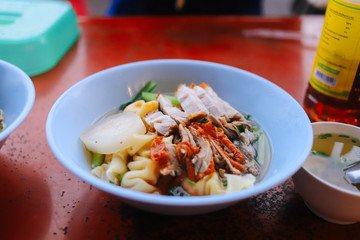 Dried egg noodle with crispy pork belly and roasted duck