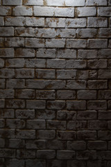 dirty aged birck wall backdrop with light from center top.