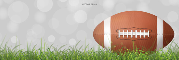 American football ball with background of green grass field and light blurred bokeh. Vector. © Lifestyle Graphic