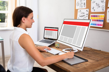 Obraz na płótnie Canvas Designer Using Computer