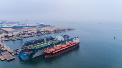 Fototapeta na wymiar Crane ship or oil tanker ship repair in shipyard. Can use for shipping or transportation concept.