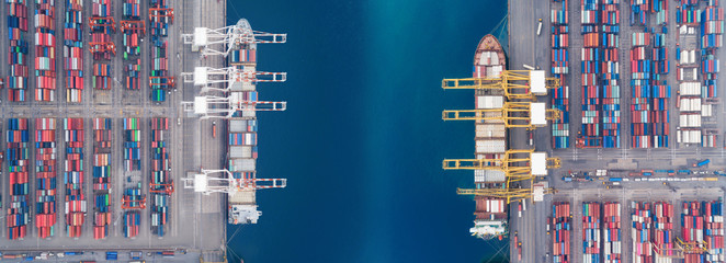 Aerial view panoramic sea port warehouse and container ship or crane ship working for delivery containers shipment. Suitable use for transport or import export to global logistics concept.