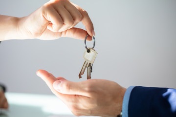 Estate Agent Giving House Key To Man