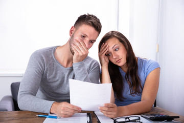 Couple Looking At Invoice