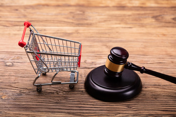 Judge Gavel And Shopping Cart On Table