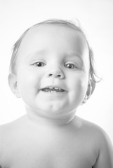 Black and White close up studio shot of cute smiling baby girl with no clothes on white background