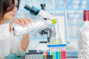 Fototapeta premium Young female technician in the quality control laboratory of wine quality inspection