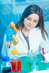 Young attractive female scientist  load liquid sample substance probe in the scientific chemical...