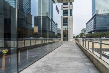 empty pavement through the modern office buildings