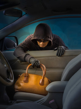thief stealing women handbag from car