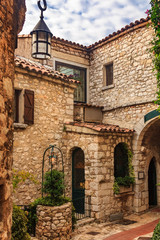 Fototapeta na wymiar Old buildings and narrow cobblestone streets in a picturesque medieval city of Eze Village in South of France along Mediterranean Sea