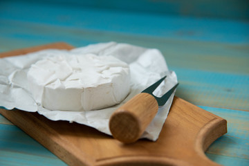 cheese camembert or brie on blue wooden background
