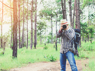 Nature photographer take photos with camera in forest