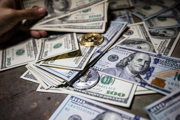 golden bitcoin coin on us dollars close up