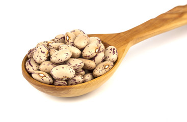 Haricot beans in a wooden spoon  isolated on white background
