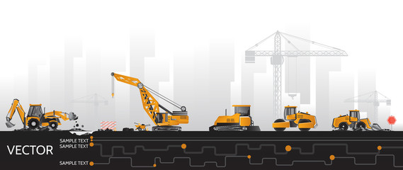 Construction equipment, road repair and underground communications with the background of buildings and cranes.