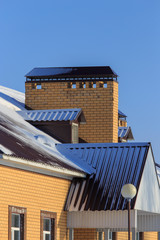 Roof of the house in the snow in winter