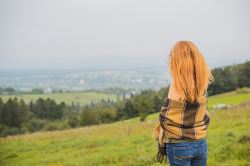 Fall, nature and people concept - Young beautiful woman with red hair have a rest in autumn time. Pretty nice woman traveler is relax. Enjoying mountains, concept adventure active vacations outdoor 