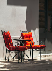 View of the metal chairs in front house on the street of Nafplio, Greece