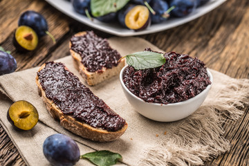 Breakfast from homemade plum jam bread and ripe plums.