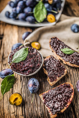 Breakfast from homemade plum jam bread and ripe plums.