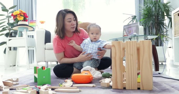 Cute little baby with mom. Mother and son playing education toy. boy and woman playing together.