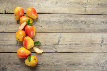 Ripe pears on rustic wooden table