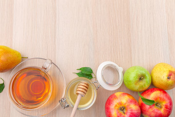 Jewish holiday Rosh Hashanah background with honey and apples on wooden table.
