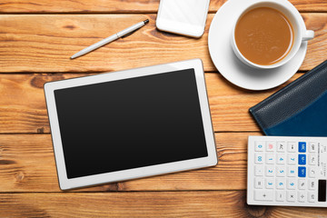 Fototapeta na wymiar digital tablet and coffee cup on wooden table