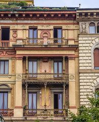 Fototapeta na wymiar Vertical: Apartment buildings in historic neighborhood of Milan, Italy