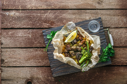 Kleftiko slowly cooked lamb with vegetables and feta cheese. Traditional Greek dish. Copy space