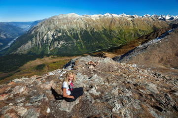 Fototapeta premium Young blond caucasian woman in the Caucasus mountains,