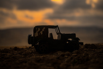 Military silhouettes fighting scene on war fog sky background, Fighting silhouettes Below Cloudy Skyline At sunset. Battle scene. Army jeep vehicle