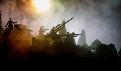 War Concept. Military silhouettes fighting scene on war fog sky background, World War Soldiers Silhouettes Below Cloudy Skyline At night. Attack scene. Selective focus Tanks battle. Decoration