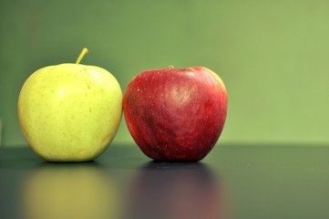 Two fresh apples on green background with copy space. Selective focus
