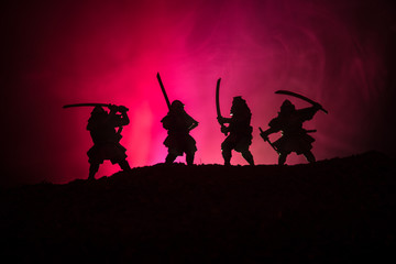 Silhouette of two samurais in duel. Picture with two samurais and sunset sky