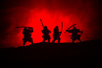 Fototapeta na wymiar Silhouette of two samurais in duel. Picture with two samurais and sunset sky