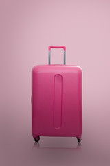  Traveler pink suitcase or cabin size luggage on pink background with shadow, Journey and travel concept