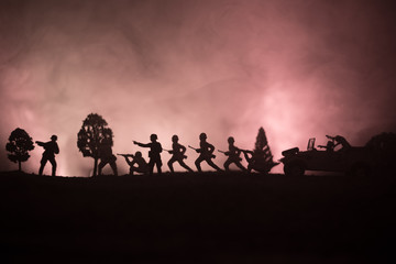Fototapeta na wymiar War Concept. Military silhouettes fighting scene on war fog sky background, World War German Tanks Silhouettes Below Cloudy Skyline At night. Attack scene. Armored vehicles.